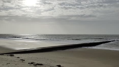 panorama of breaking waves on baltic sea beach at evening