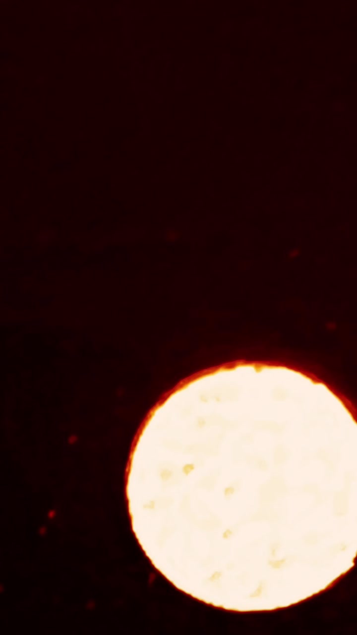 Bright Glowing Circular Light Source Against Dark Background