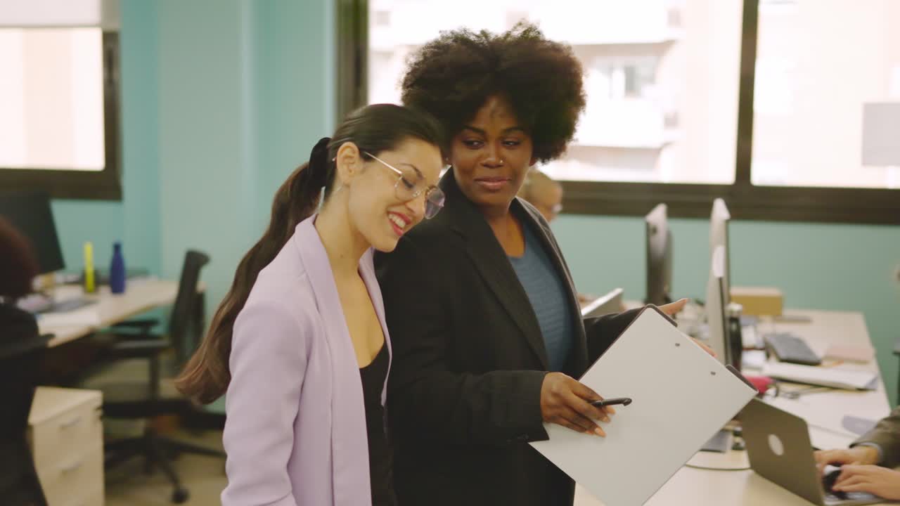 Colleagues and friends walking together in a coworking space