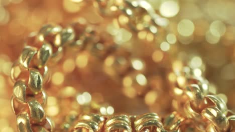 closeup shot of gold necklaces with rotating