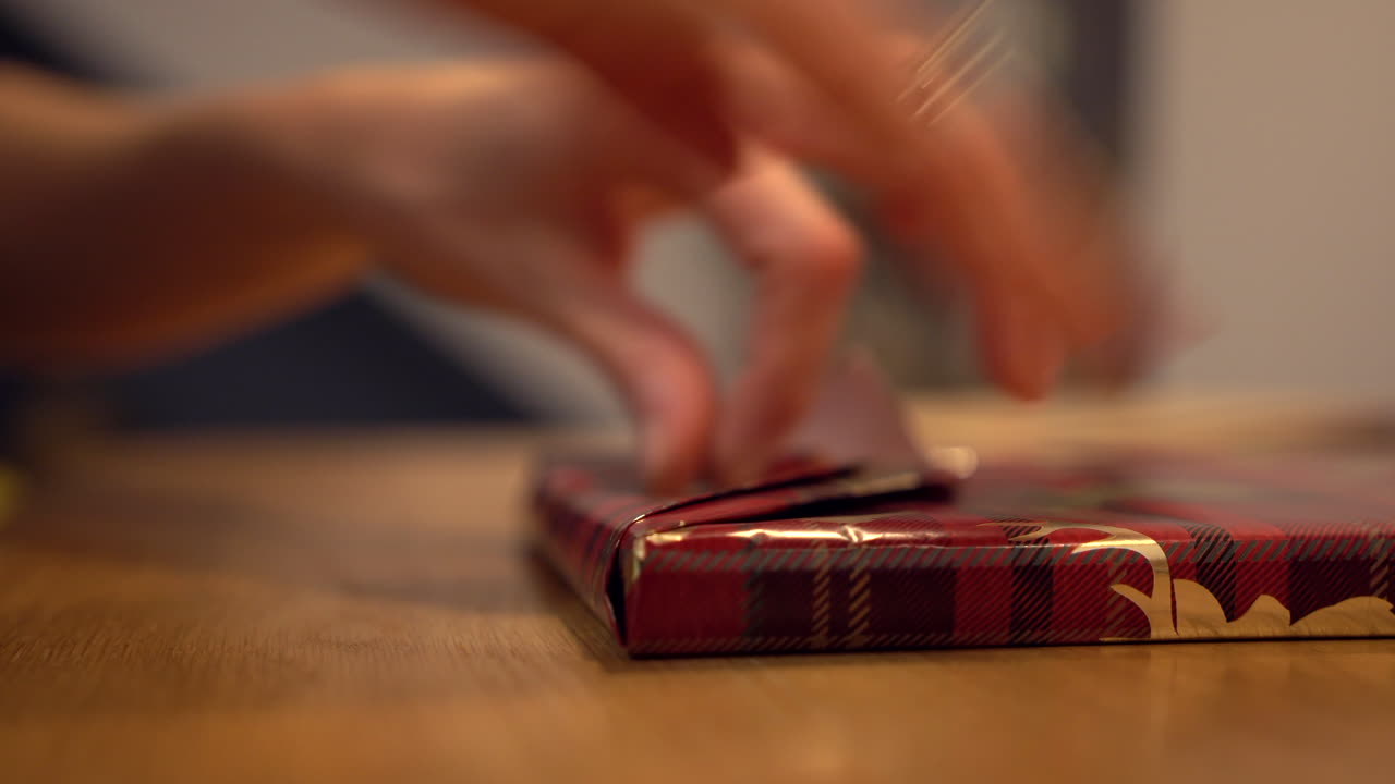 금색 순록이 있는 빨간색 장식 종이로 선물 포장하기