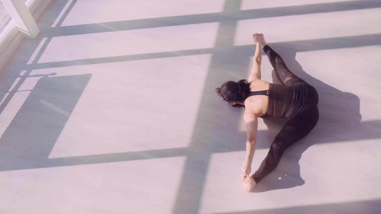 An Artistic Representation of a Flexible Yoga Practice in a Minimalist Studio Setting, Showcasing Balance, Strength, and Concentration Under Soft Lighting