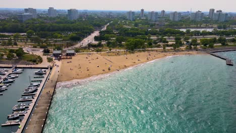 aerial-drone-footage-of-a-beautiful-sandy-Chicago-beach-during-a-sunny-afternoon-in-the-city