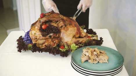 Thanksgiving or Christmas turkey dinner. Hands of a man carving a roast turkey