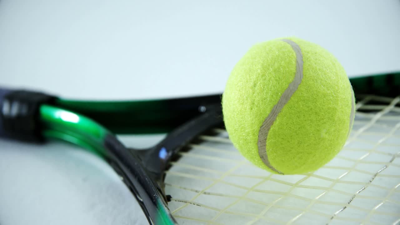 Racket and tennis ball on white background 4k