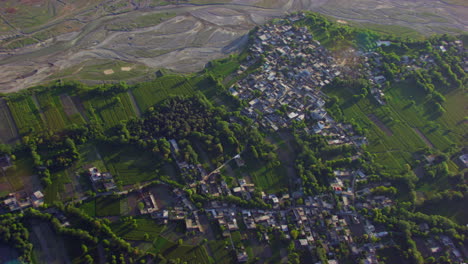 A-river-and-a-valley-Aerial-view,-Green-trees,-grass-and-forest-with-houses