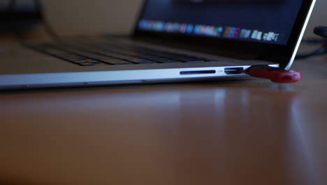 universal serial bus being inserted into a laptop.