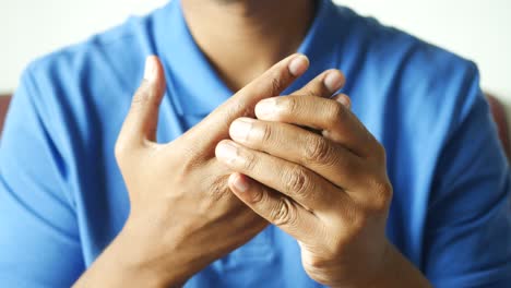 man suffering pain in hand close up