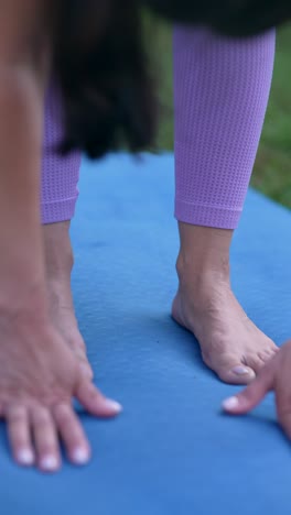 woman practicing downward-facing dog yoga pose outdoors