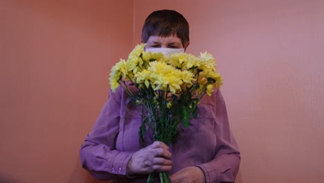 woman receiving a bouquet of yellow chrysanthemums