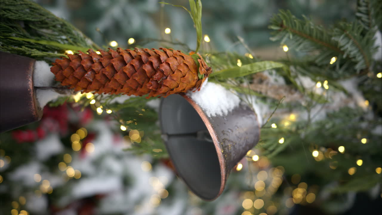 Christmas fir tree with decoratons bells outside and white snow