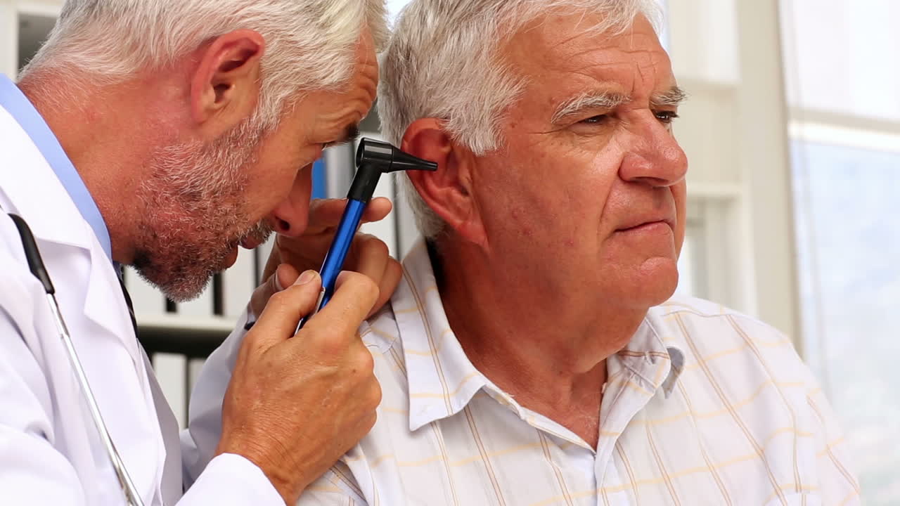 Doctor examining his patients ears