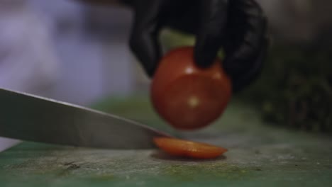 watch as a skilled chef delicately slices through a ripe tomato, revealing its juicy and vibrant interior, a testament to the freshness and quality of the ingredients