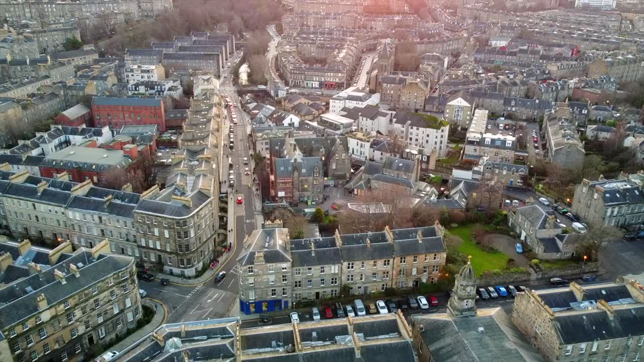 Slow motion footage of Edinburgh’s Stockbridge neighborhood, showcasing classic stone buildings, narrow streets, and a blend of residential and commercial architecture.