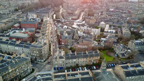 slow motion footage of edinburgh’s stockbridge neighborhood, showcasing classic stone buildings, narrow streets, and a blend of residential and commercial architecture.