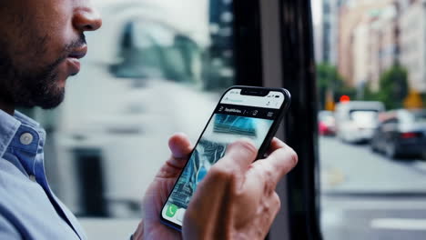man using a map app on his phone in the city