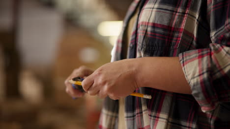 a person holding a pencil in a workshop