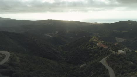 aerial of mediterrenean empty landscape with an scary thrilling mood and few houses in the mountains of sardinia