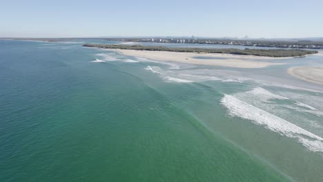 slow, foamy waves on north bribie island, queensland, australia aerial shot