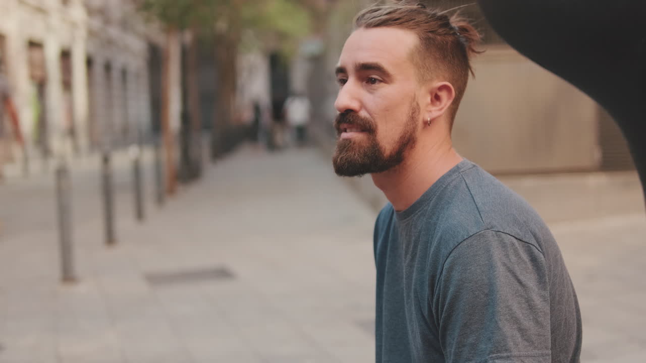 Man with beard on city street
