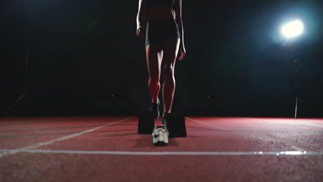 close-up legs of the athlete approach the treadmill and become in position to start the race