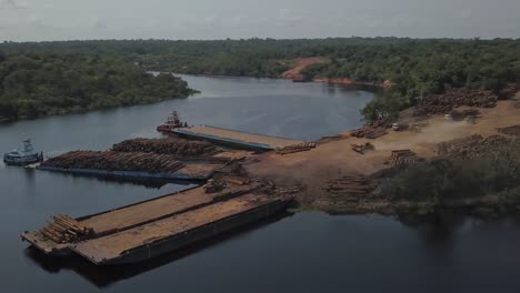 huge logging operation in brazil contributes to deforestation and climate change in the amazon rainforest - aerial parallax on amazon river