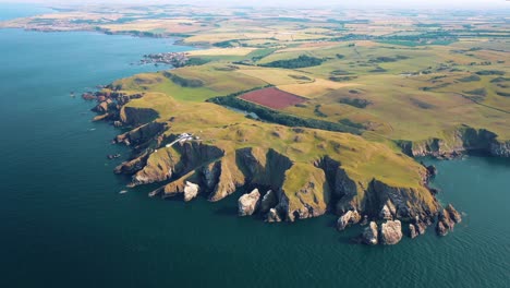 scotland from the air: st abbs head and its iconic lighthouse on dramatic cliffs, united kingdom