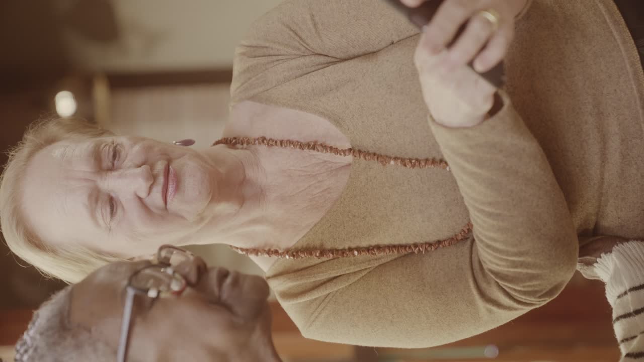 Two Elderly Women Interacting and Smiling