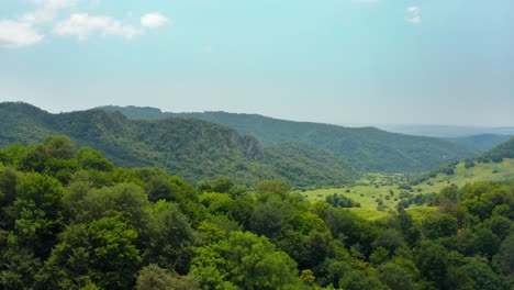 Aerial-fly-over-view-of-wild-green-forested-mountains-and-meadows-in-Kakheti-region-in-Georgia