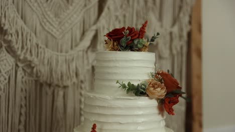 Wedding-Cake-With-Floral-Topper-At-The-Reception