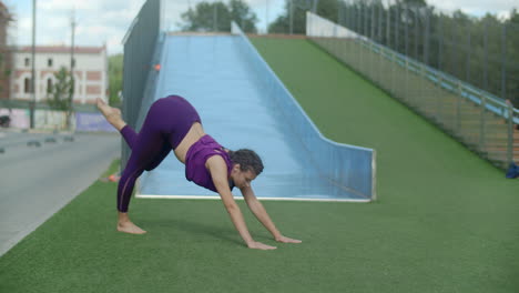 woman practicing yoga outdoors on a playground