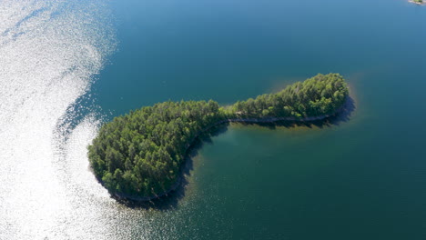 aerial view circling a uniquely shaped island on lake saimaa, summer in finland