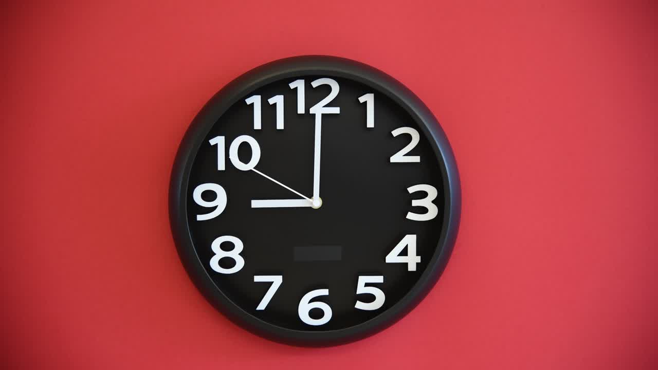 Black wall clock on red background