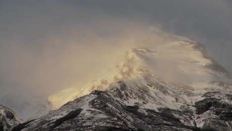 snow blows off mountain peaks