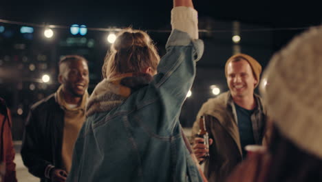 young woman dancing multi ethnic group of friends having fun on rooftop at night enjoying celebration party