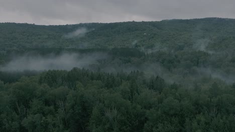 drone flying through a beautiful foggy mountain top landscape, pan right