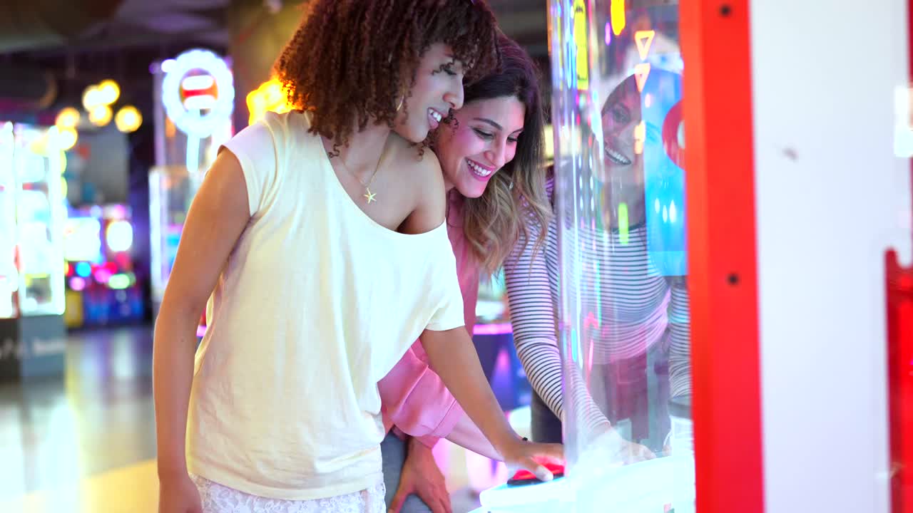 Women playing a game at an arcade