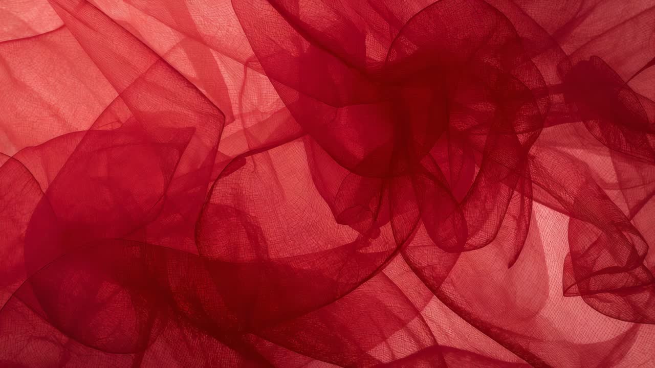 Drifting layered sheer red fabric moving as backlight shifts in studio ...