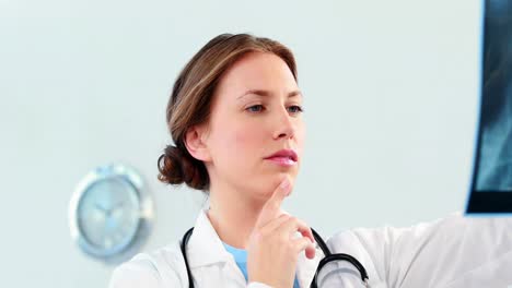 Female-doctor-examining-a-x-ray-report