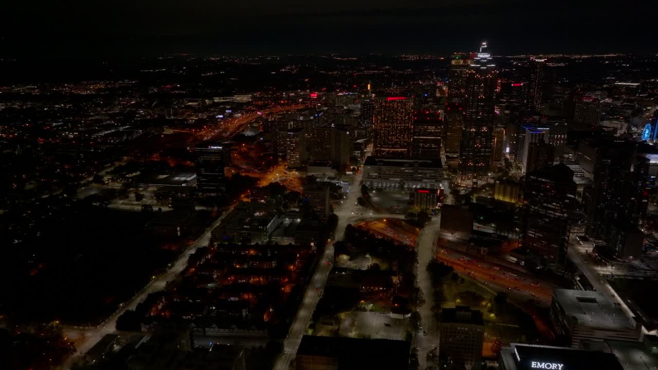 Drone view of Downtown Atlanta skyscrapers, Truist Plaza, skyline buildings and hotels at night, Establishing, Panoramic view