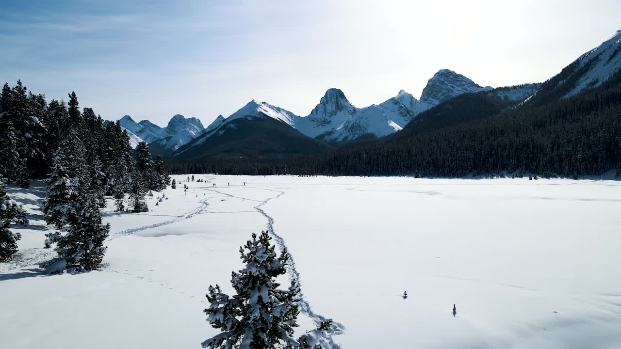 Drone shot through bridge toward snowy mountains
