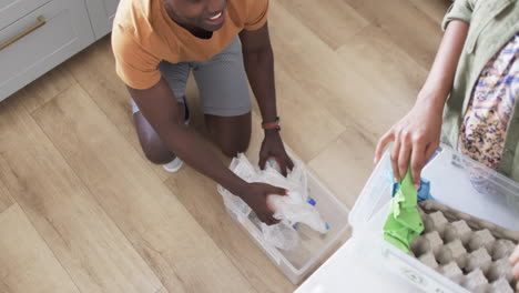 A-young-African-American-couple-is-organizing-recycling-at-home