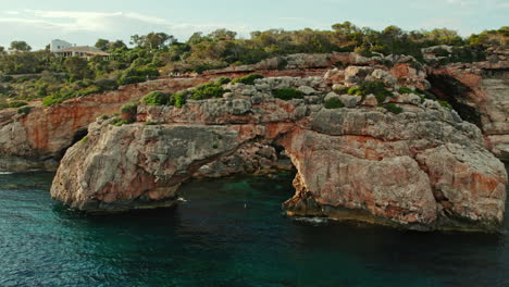 natural limestone arch es pontas and popular viewpoint mirador de es pontas in balearic islands, spain