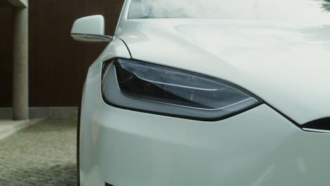 close-up of a white tesla model x headlights