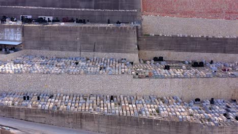 aerial view of a large terraced cemetery with many graves