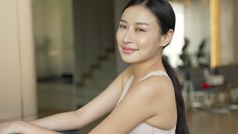 smiling asian woman in sportswear