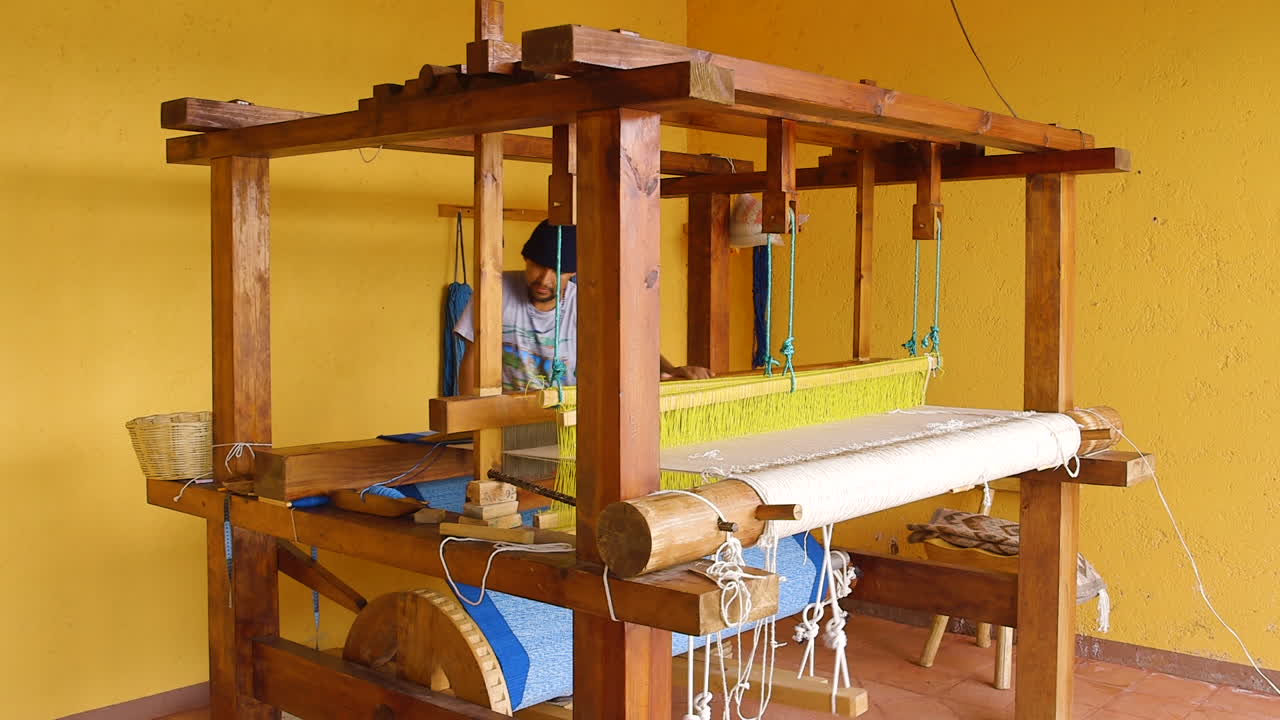 Artisan Weaving Fabric on a Traditional Wooden Loom