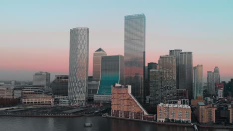 rising drone aerial shot of london canary wharf at sunset