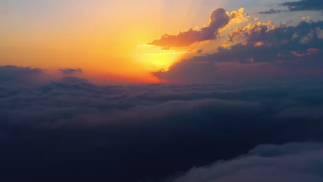 flying over the clouds with the late sun. sunrise or sunset colorful sky background.