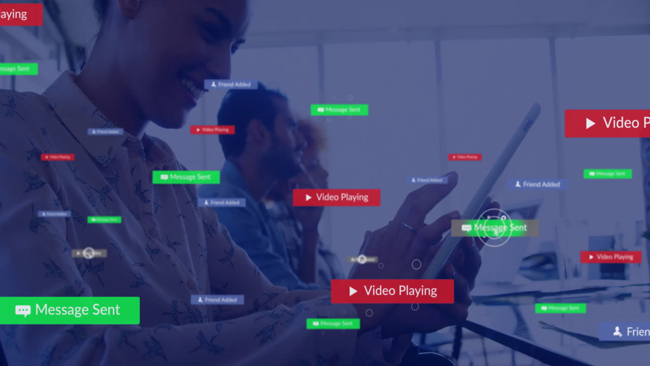 Animation of social media notifications over happy caucasian businesswoman using tablet at work